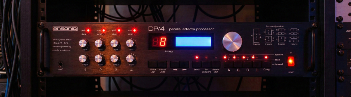 Front-panel photo of a classic 4-unit effects processor in studio lighting.